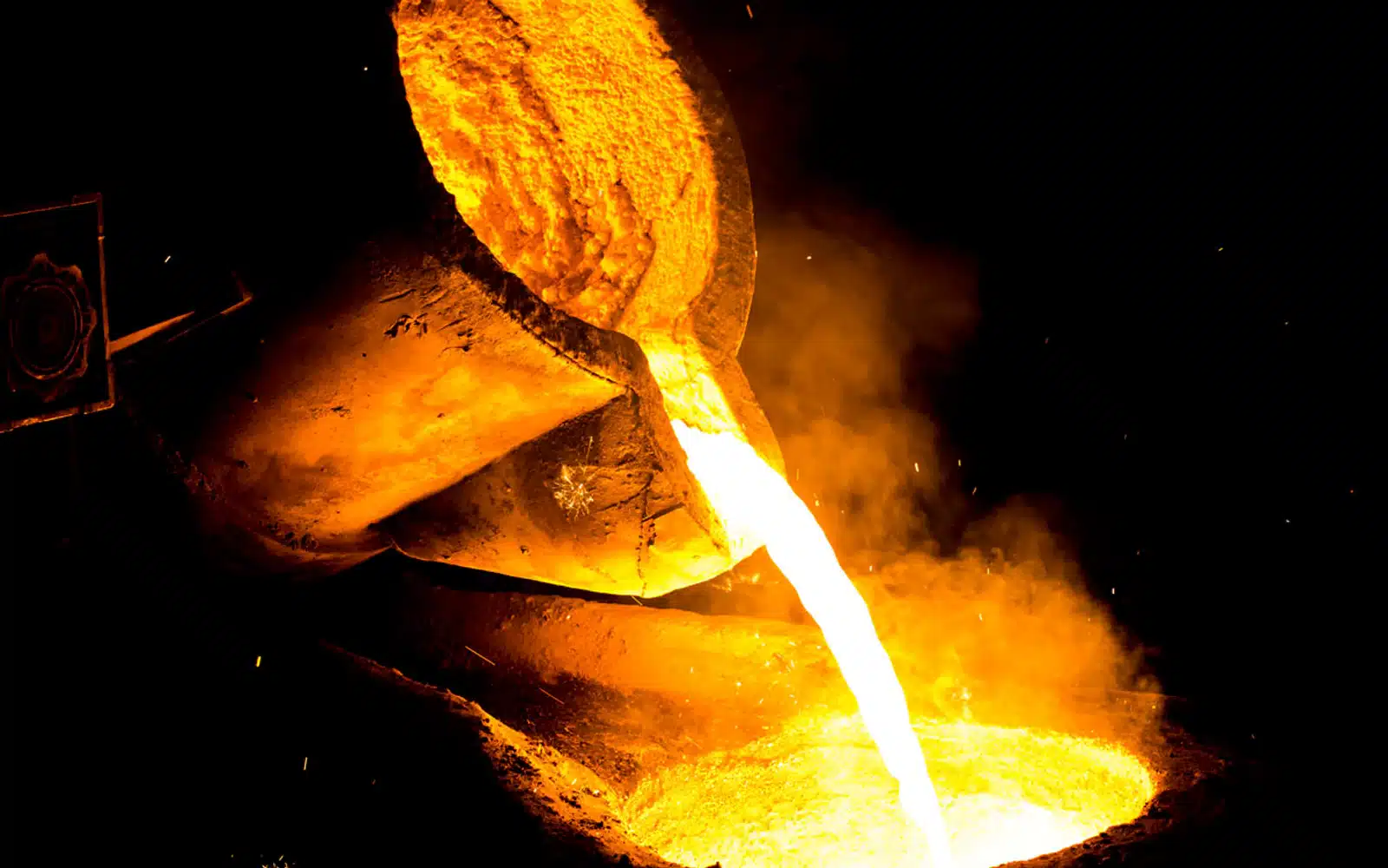 Molten copper being poured from a foundry ladle during continuous casting