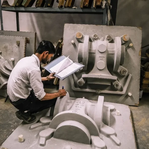 Engineer reviewing casting mould plans on the foundry floor