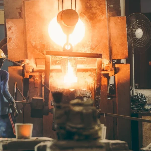 Foundry workers pouring molten metal at a high-volume alloy and stainless steel casting facility