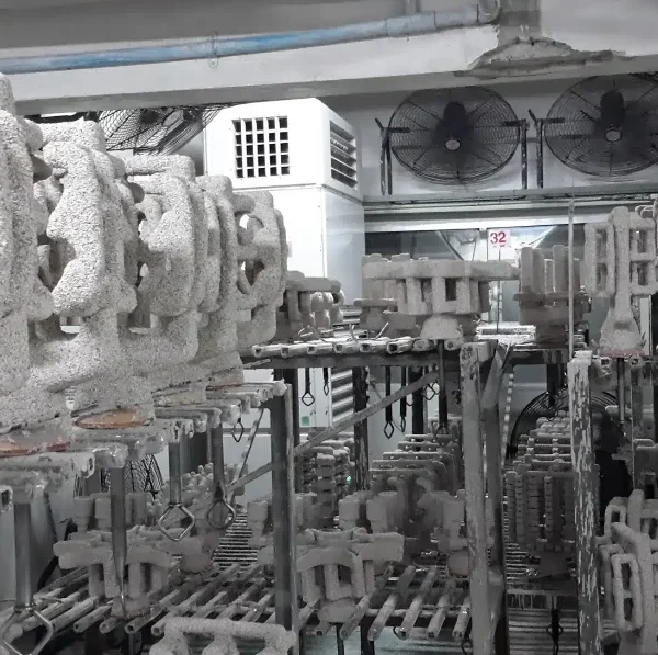 Investment casting ceramic shell moulds drying on racks in a climate-controlled room