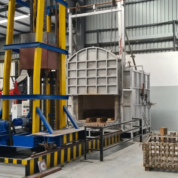 Heat treatment ovens and quench tower on an investment casting foundry floor