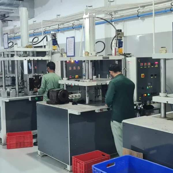 Operators working at wax injection press stations in an investment casting wax room